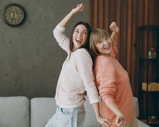 Kaksi eri-ikäistä naista tanssii selät vastakkain.